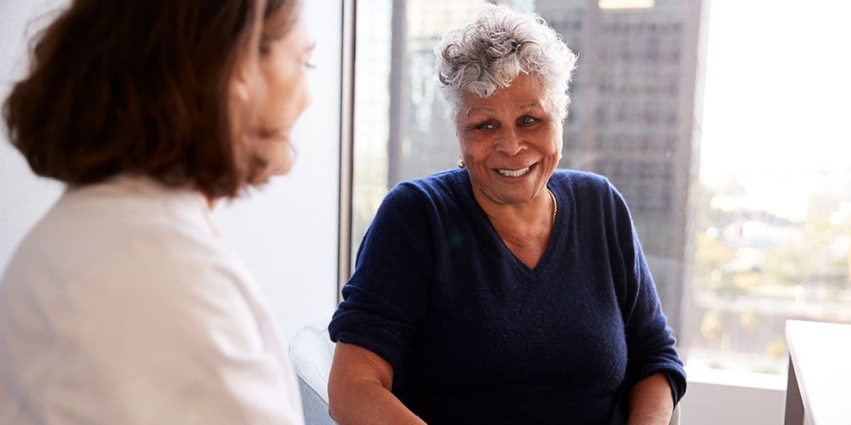 senior woman talking to doctor