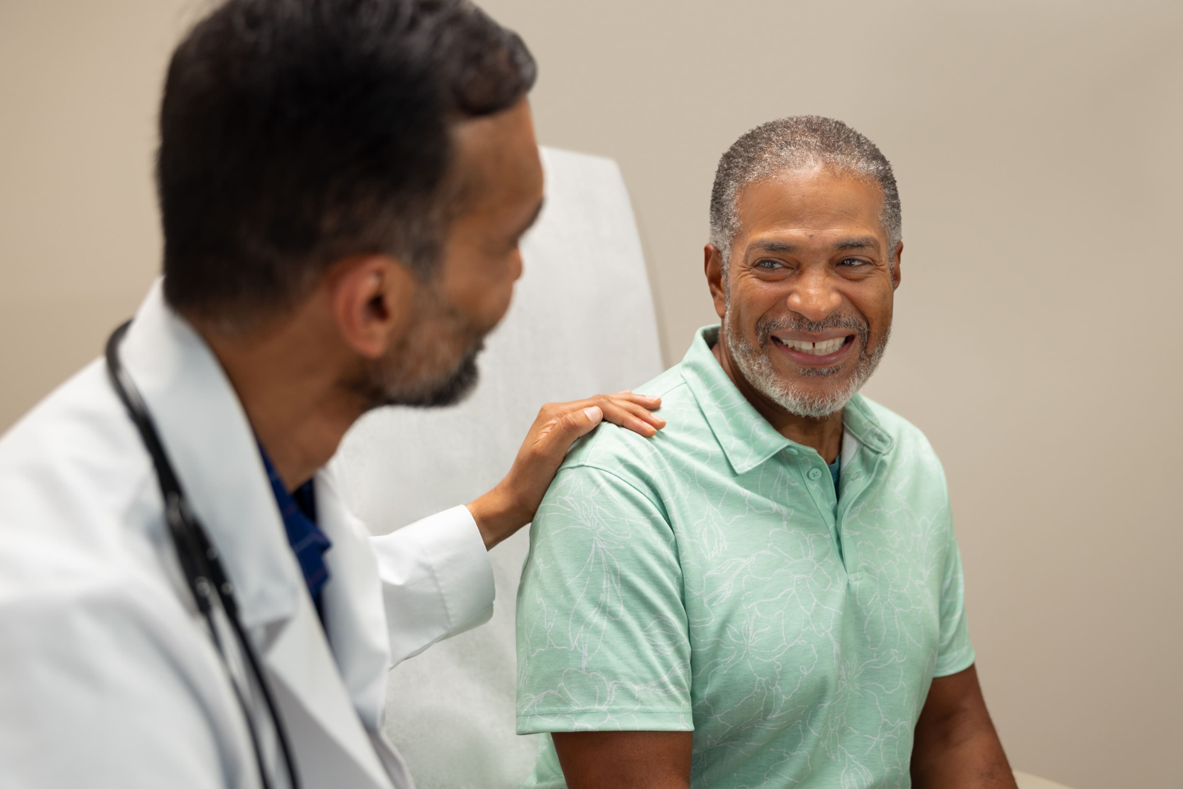 woman sitting next to doctor 
