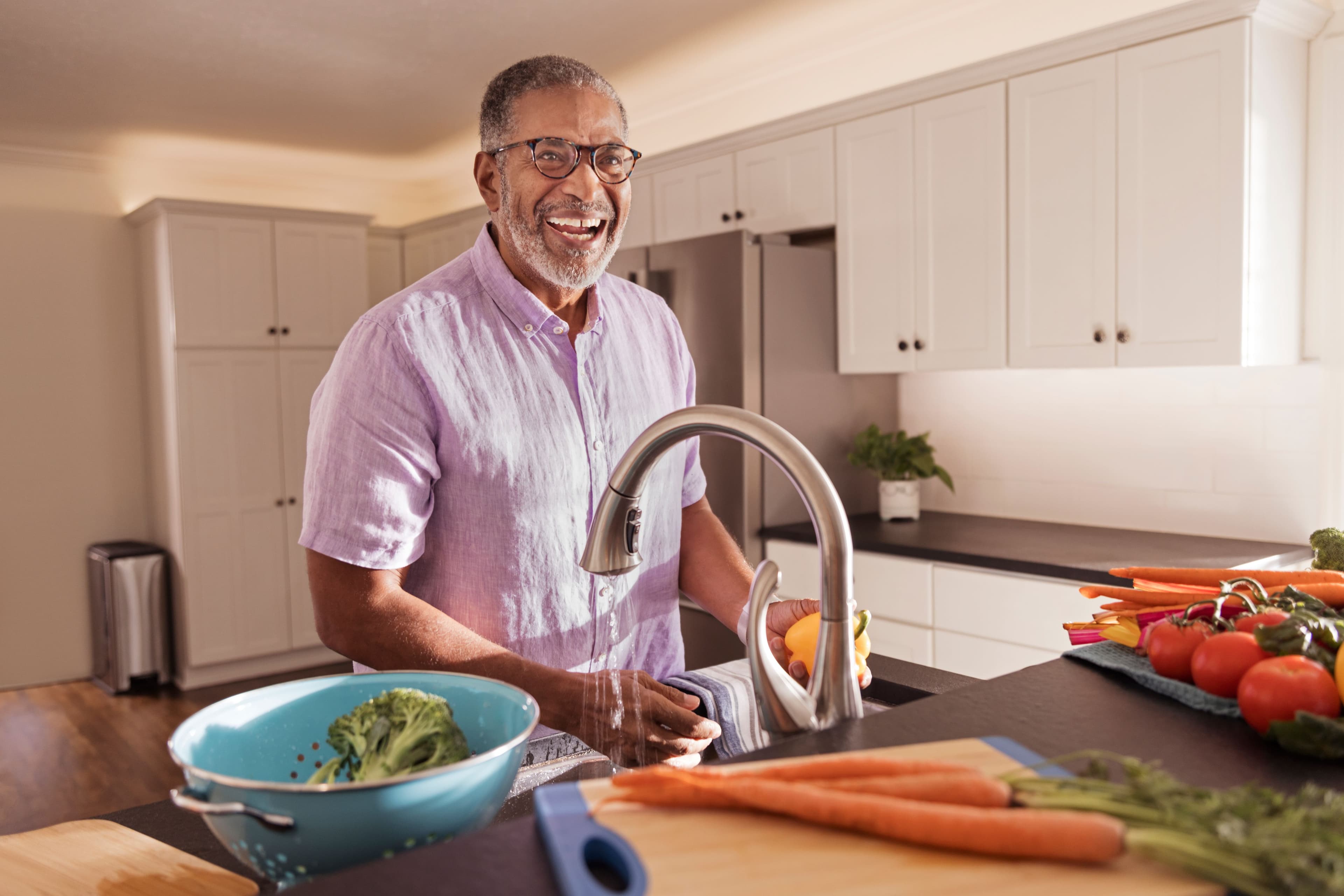 senior man cooking in kitchen