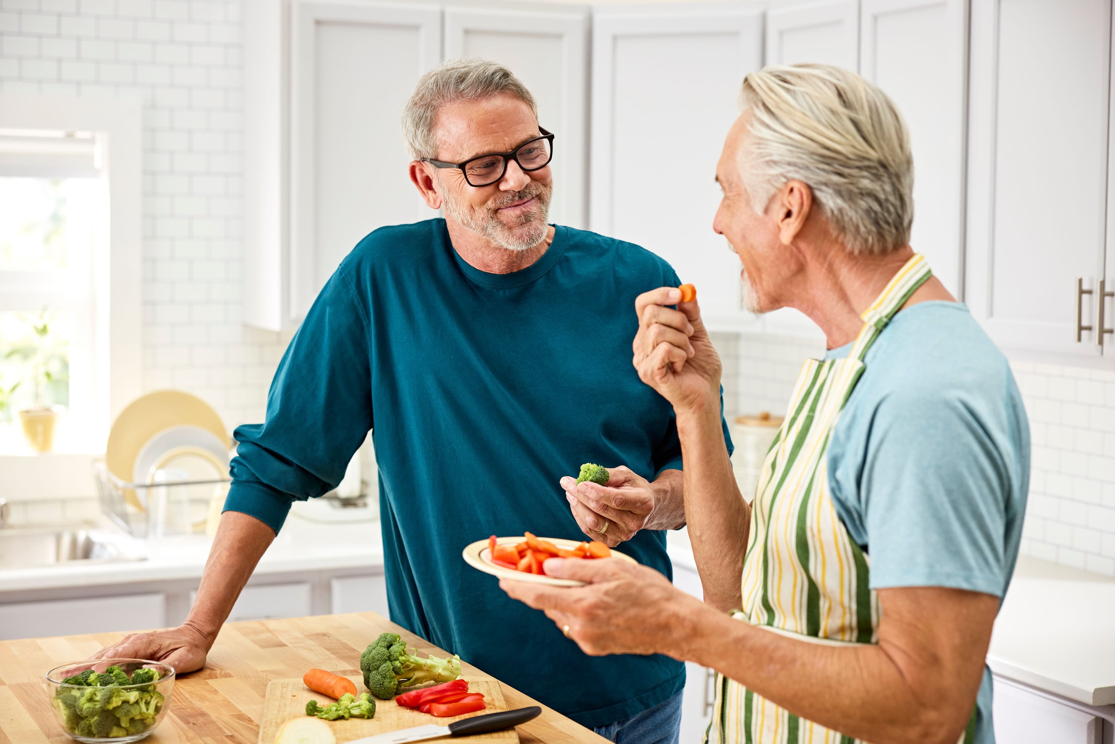 senior man cooking in kitchen