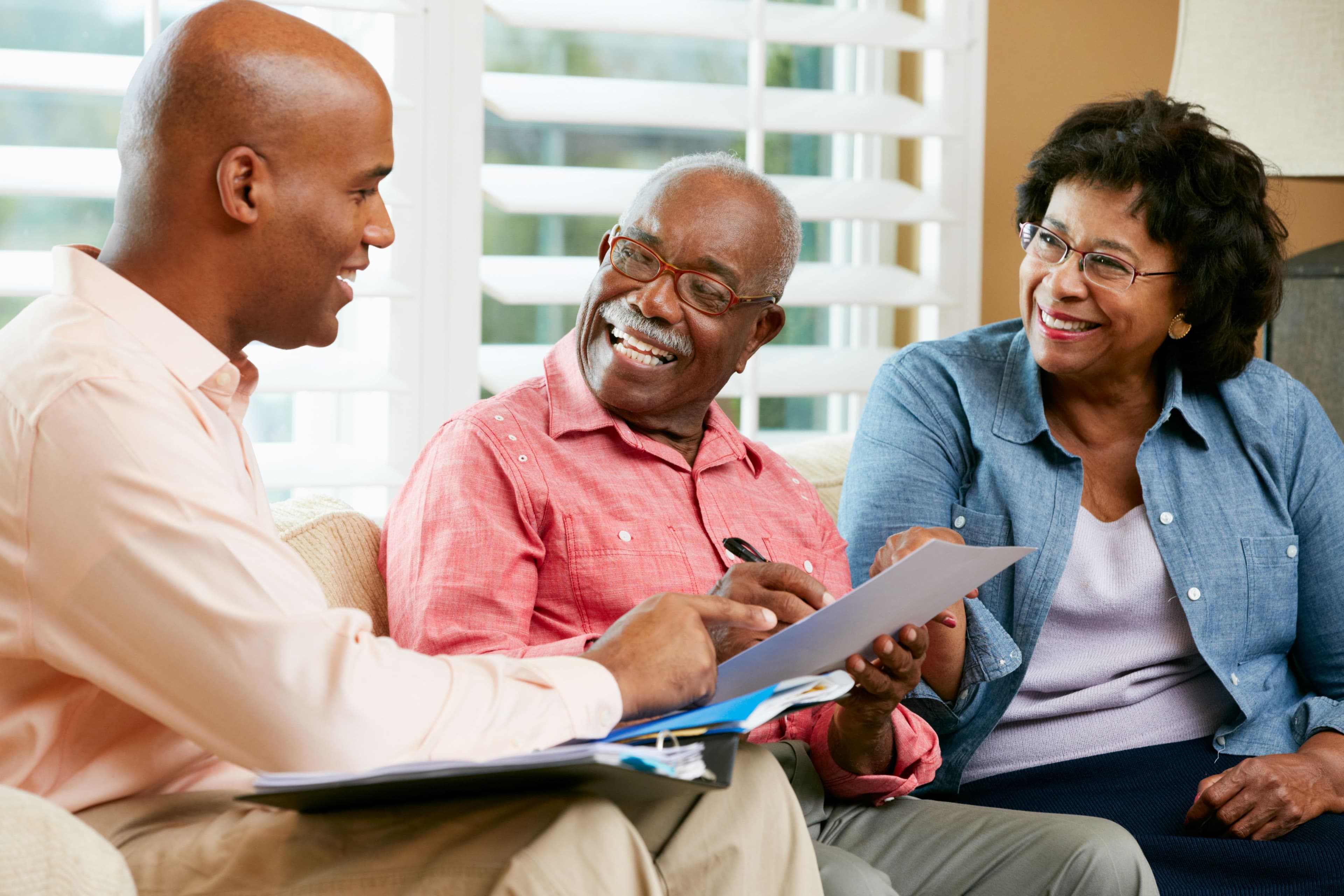 Financial Advisor Talking to Senior Couple at Home